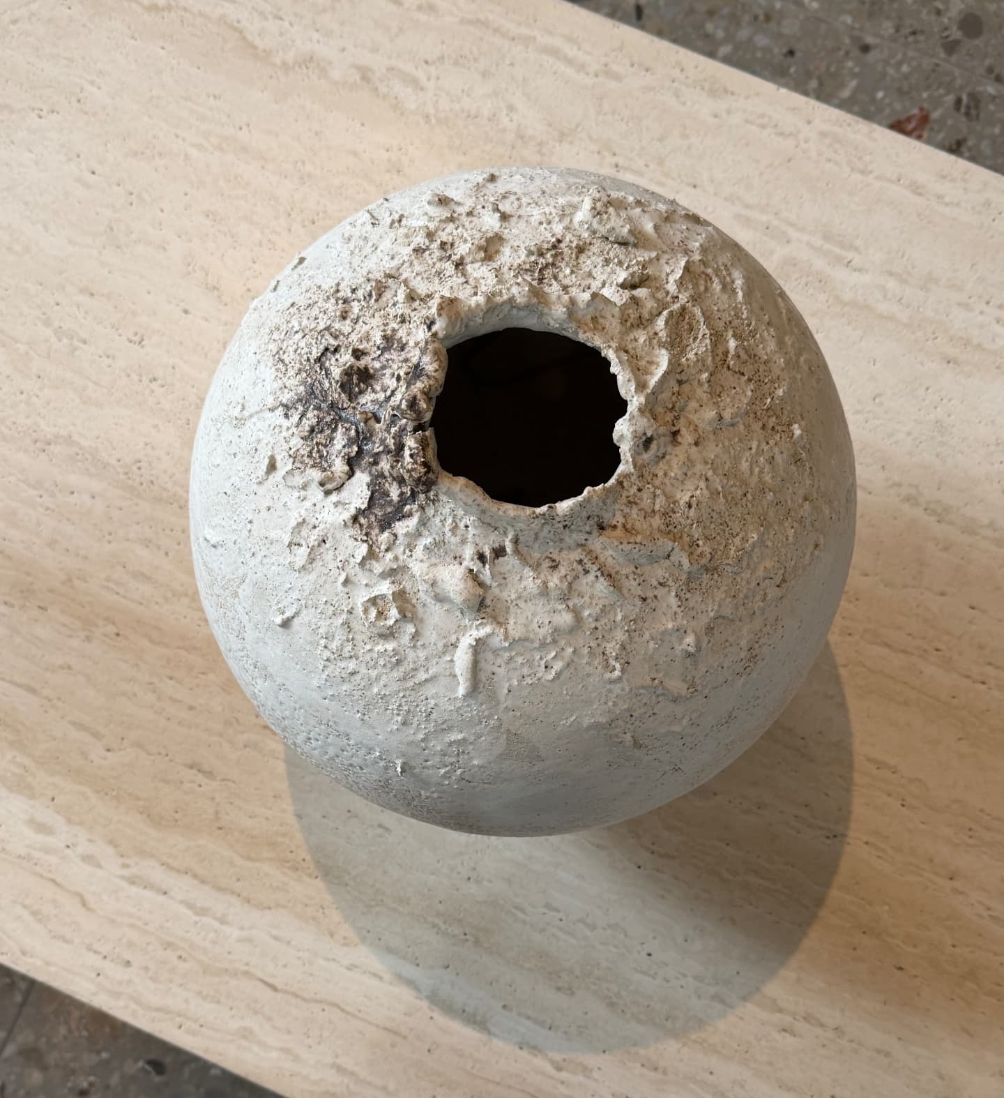 Textured ceramic vessel on stone